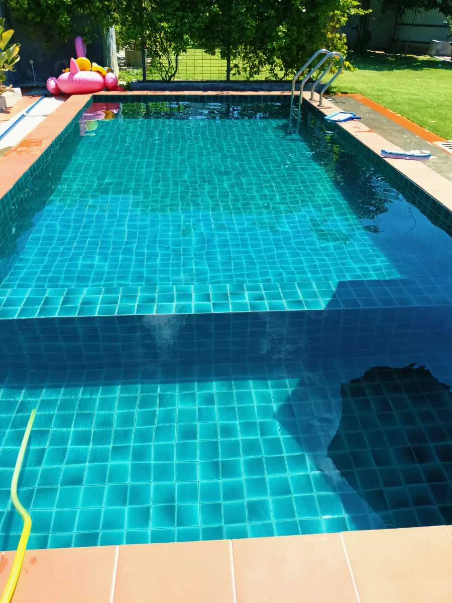 Completed blue tile pool with clear water