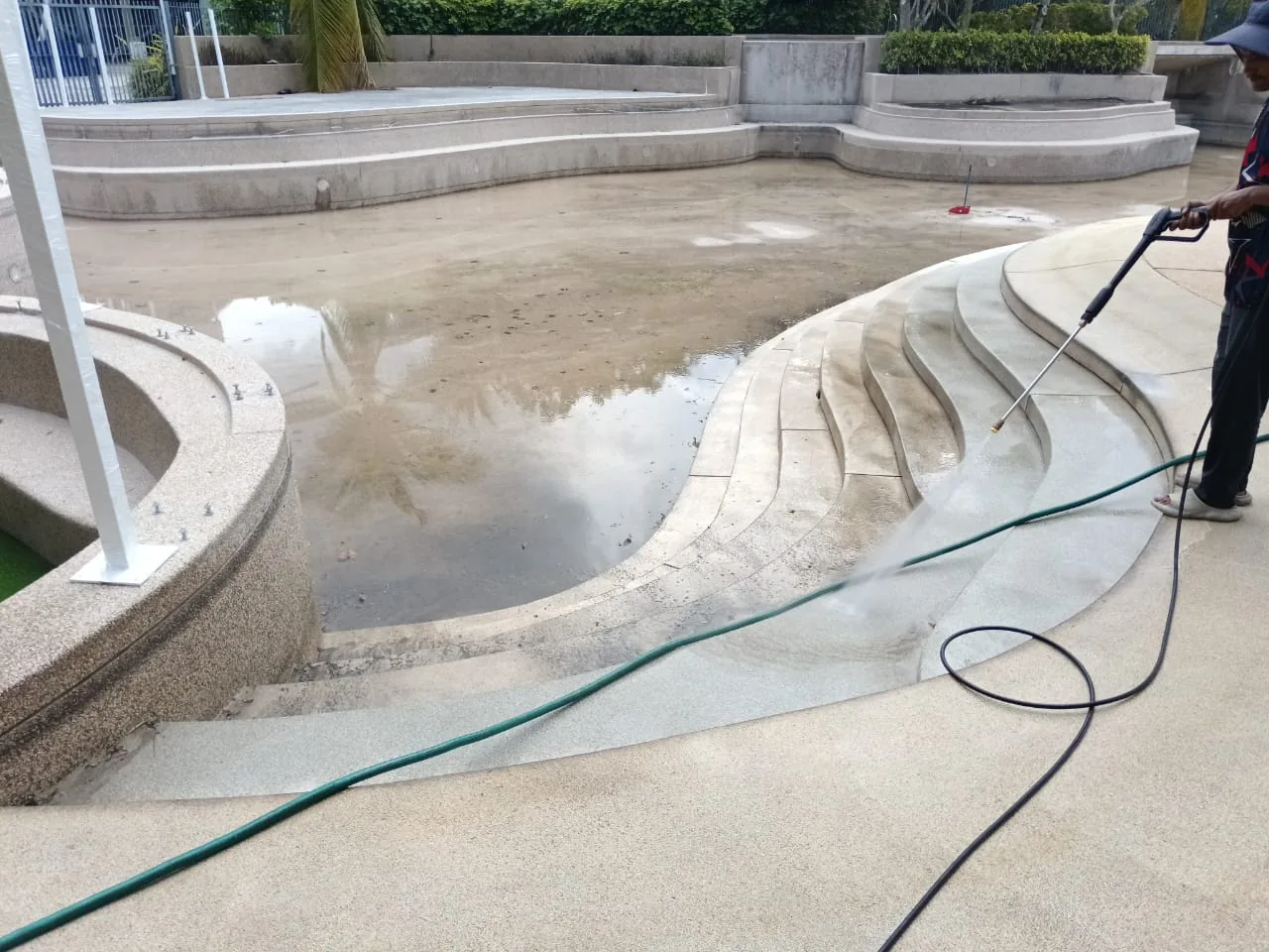 Large pool deep cleaning and pressure washing in progress